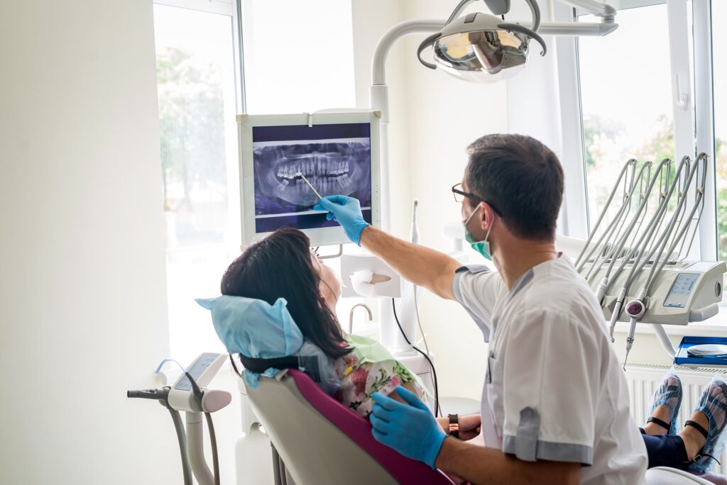 dentist and patient looking at an X-ray